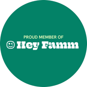 A green circle with the words PROUD MEMBER OF Hey Famm in white and yellow bold font. A small smiling face icon appears to the left of the text.